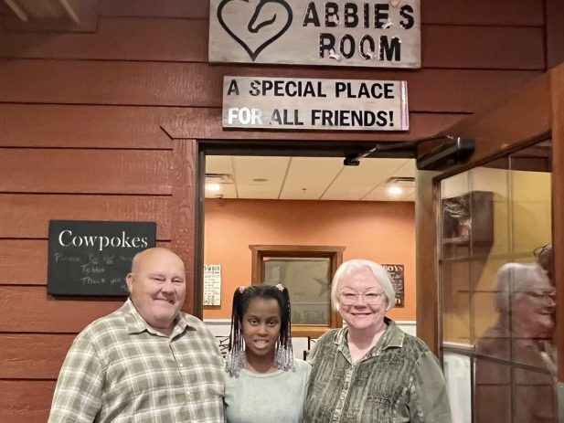 Abbie with her Grandparents outside of Abbie's Room