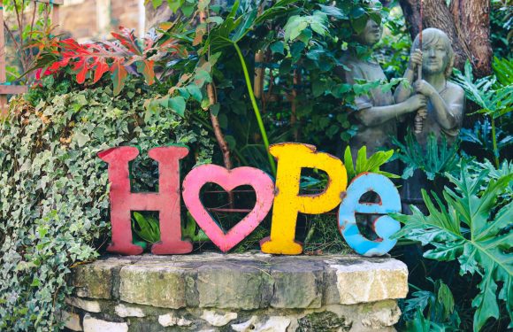 Garden with plants and statue of the word Hope in colorful letters