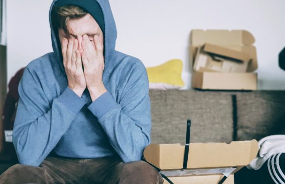 Man with head in hands depicting anxiousness