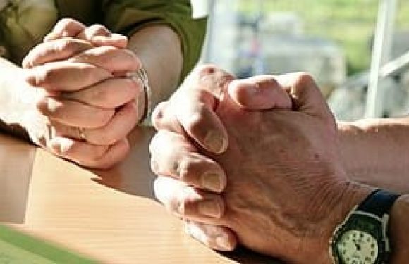 Man and woman with Hands folded for prayer