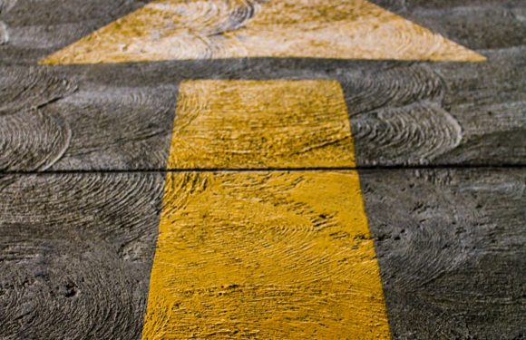 Yellow Directional Arrow on the Road