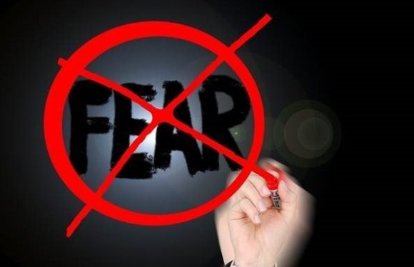 hand writing fear and crossing it out