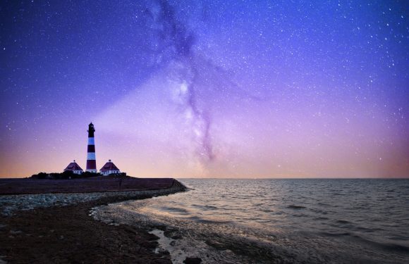 Lighthouse projecting light into the night