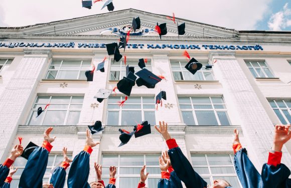 Graduates Tossing caps into the air