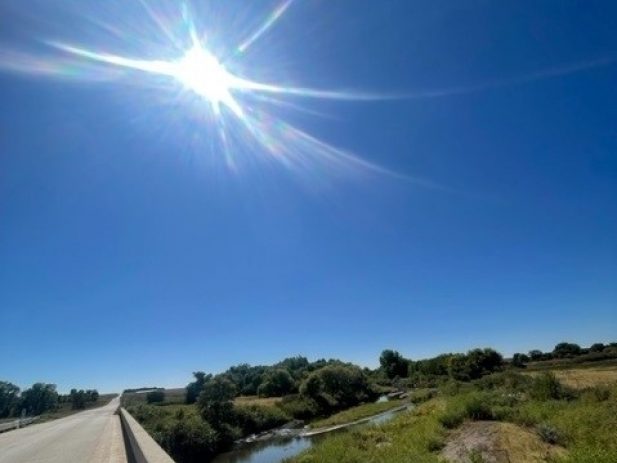 Bright Sun overlooking a peaceful creek