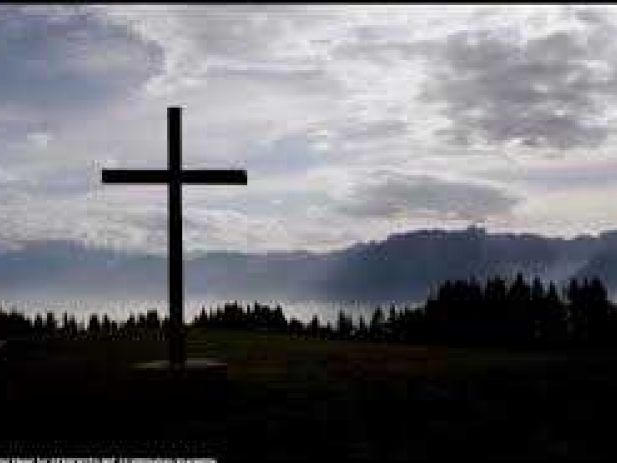 Cross with Mountains & tress in the background