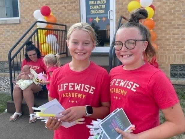 2 girls helping with Lifewise Open House in Boyden, IA