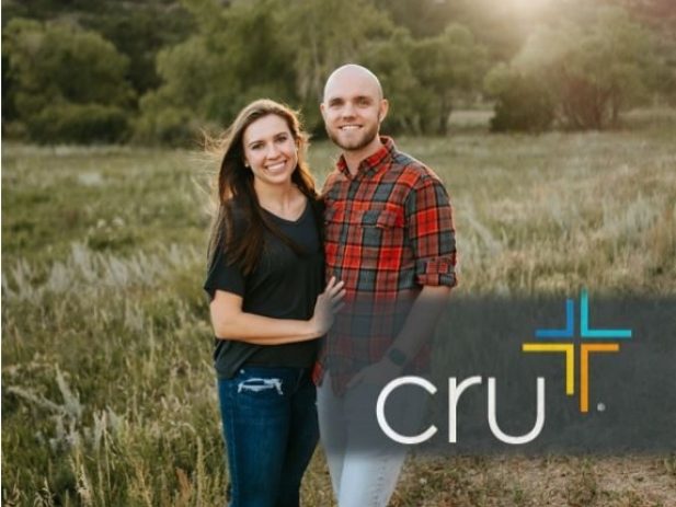 husband and wife missionary standing side by side with cru logo in corner