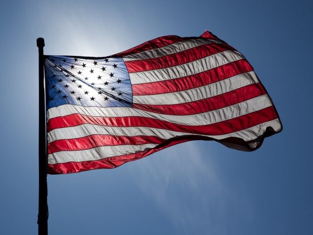 US Flag with sun shining through