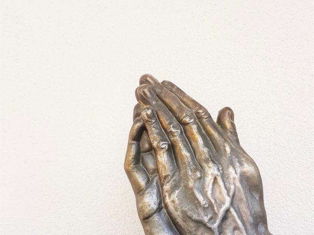 praying hands of a statue