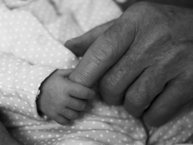 Grandparent and Baby holding hands