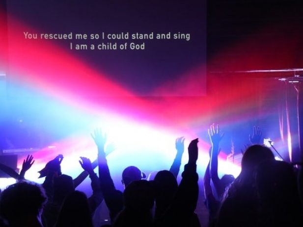 People raising their arms in praise - rejoicing