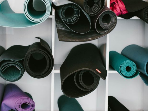 Yoga mats stored on a shelf