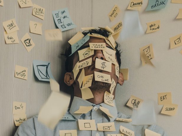 Man covered in "to do" post it notes