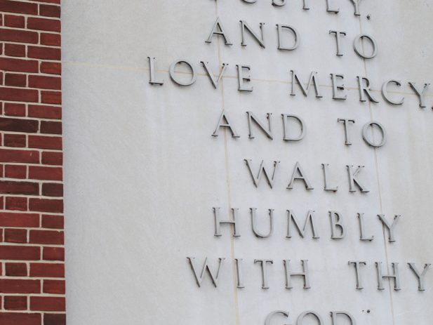 Micah 6:8b on a cement wall. "and to love mercy, and to walk humbly with thy God."