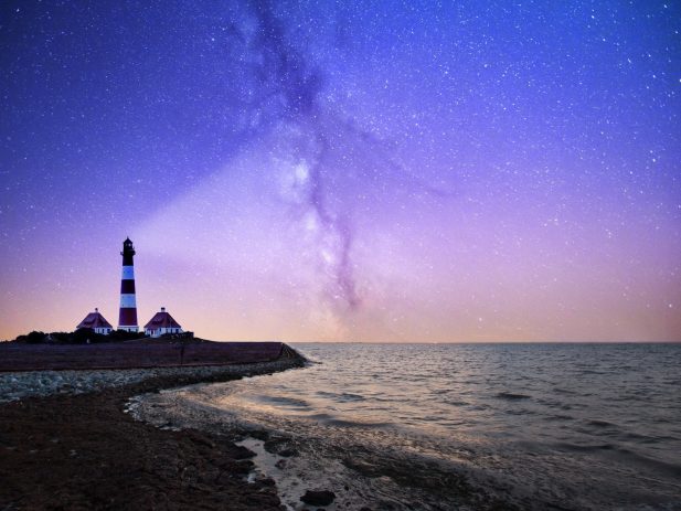 Lighthouse projecting light into the night