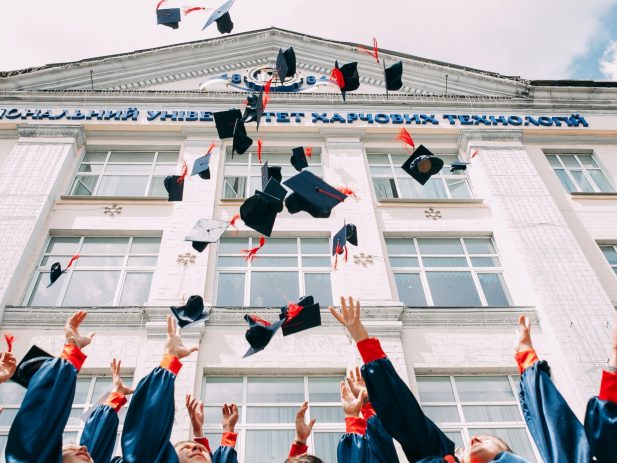 Graduates Tossing caps into the air