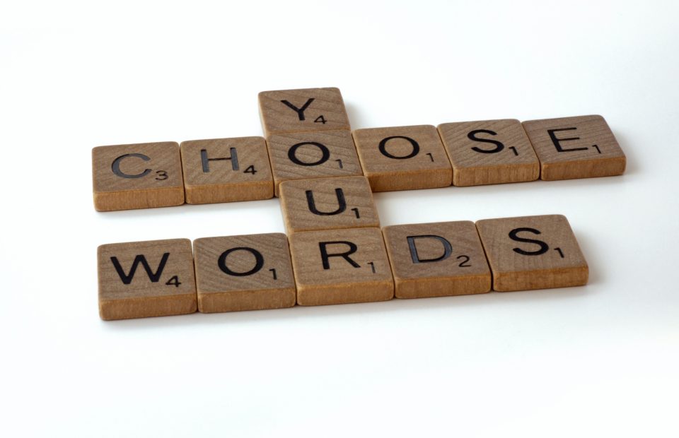 Scrabble letters that say Choose Your Words.