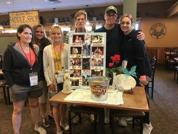 Nicole's family with a table of memorabilia