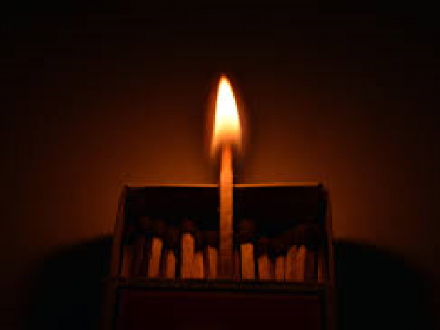 Single Match Burning in a box of matches